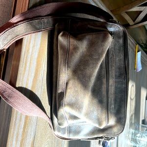 Latico handcrafted brown leather purse with multiple zipper pockets.